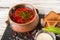 Ukrainian national dish borscht. Russian borsch in a clay pot with onions, sauce, sour cream, bread croutons, roasted garlic