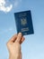 Ukrainian passport against the sky