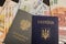 Ukrainian passport and Russian workbook against the background of euro bills