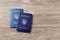 Ukrainian passports on wooden background, top view. International relationships