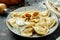 Ukrainian or Polish traditional dish - Pierogi or Varenyky dumplings with stuffed with cabbage and sour cream on a dark
