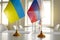 Ukrainian and Russian flags at negotiations aimed at stopping war and restoring peace