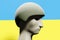 Ukrainian soldier with military helmet on Ukrainian flag background