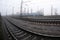 The Ukrainian suburban train rushes along the railway in a misty