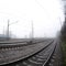 The Ukrainian suburban train rushes along the railway in a misty