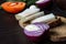 Ukrainian traditional food is lard salo with bread with red onions on the background of the tomato with garlic on wooden table