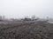 Ukrainian village in winter. Old house and fields in hoarfrost