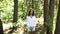 Ukrainian woman in embroidered dress in the forest gathering herbs in basket