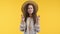 Ukrainian woman praying with crossed fingers on yellow background. Girl begs someone satisfy her desires, help with