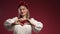 Ukrainian woman showing sign of shape heart.Red background. Women health,charity