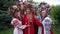 Ukrainian young and adult women hugging smiling looking at camera standing outdoors. Portrait of happy confident