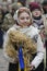 Ukrainians sing Christmas carols as they carry a huge decorated star of Bethlehem and sheaves of wheat in their hands during a