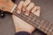Ukulele in close up with hand placing chords. The chord is G. Portable string instrument. Music creation concept.  wooden