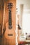 Ukulele: Close up of ukulele and flutes, ready to play, hanging on a wooden bookshelf