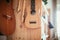 Ukulele: Close up of an ukulele, ready to play, hanging on a wooden bookshelf