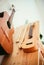 Ukulele: Close up of an ukulele, ready to play, hanging on a wooden bookshelf