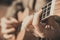 Ukulele - Closeup in the open air - Women`s hands - Instrument tuning