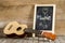 Ukulele guitar and blackboard with the word Music written on wooden background