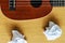 Ukulele guitar with paper scraps