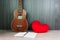 ukulele and red heart with blank note book with pencil