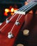 Ukulele small guitar close up stings, fireplace on the background. Musical concept, guitar fret board macro, fire in chimney, cos