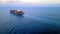 ULCV container ship sails on open water fully loaded with containers and cargo.