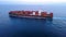 ULCV container ship sails on open water fully loaded with containers and cargo.