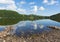 Ullswater by Pooley Bridge Lake District Cumbria rocky shore blue sky and sunshine