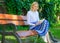 Ultimate best book list. Woman blonde take break relaxing in park reading book. Girl sit bench relaxing with book, green