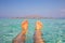 Ultimate holiday feeling, feet in clear blue water at a paradise and tropical location