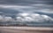 Ultra long exposure of skyscrappers near sea with clouds