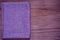 Ultra purple Postcard sample, linen fabric surface on wooden table with free copyspace for greeting text,