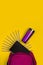Ultra-violet backpack view from above on a yellow background, pencils, notepad, metallic ultraviolet cup, set for creativity, stat