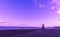 Ultra violet beach sunrise with lifeguard wooden tower