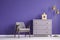 Ultra violet living room interior with retro armchair and chest