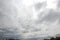 Ultra wide angle shot of dark clouds floating directly overhead in stormy sky