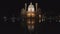 An ultra wide night shot of st charles church reflected in a pool at vienna