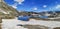 Ultra wide panorama of the lake in the Gotthardpass with snow