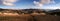 Ultra wide panorama of multi coloured mountain range on a sunny day in Landmannalaugar National Park, Iceland