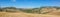 Ultra wide view of Tuscan hills with many cypresses