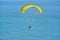 An ultralight trike sails along near beach