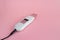 Ultrasonic peeling device with two modes with black cable on pink background