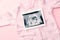 Ultrasound photo pregnancy baby. Fashion cute baby cloth with ultrasound pregnancy picture on pink background. Concept