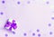 Ultraviolet festive holiday background with goft box and pink confetti.