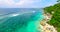 Uluwatu cliffs, Bali, Indonesia. Aerial view of the cozy villas on the ocean beach. Summer time holidays.