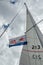 Ulyanovsk, Russia - July 27, 2019. Flag of the Russian Navy against the blue sky with clouds and a triangular sail