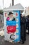 Uman,Ukraine, 13.09.2015: Tent with an image of man and signboards written in Hebrew and near which Jewish men stand in Kippah