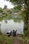 Uman,Ukraine,13.09.2015 Two men in Kippahs are sitting near the river and point by their hands on other side where there are t