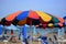 Umbrella on the beach colored like the rainbow