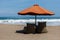 Umbrella and empty bean bags on Berawa Beach, Bali, Indonesia